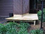 Floating deck level with steps with drainage between wall – by DeckResurrect