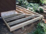 Floating walkway supported on 8" concrete footers with double rims prior to decking – by DeckResurrect