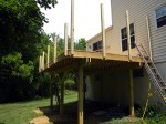 Upper posts tacked with nails, leveled then bolted – by DeckResurrect