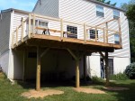 Final stages of custom deck with railing by DeckResurrect